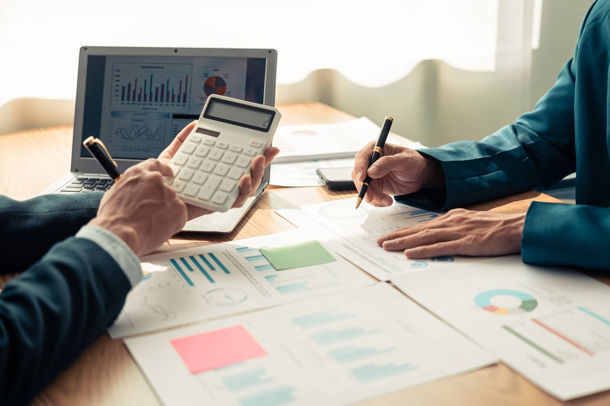 Financial team reviewing charts and graphs together during a business meeting